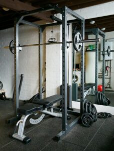 power rack and workout bench for home gym with safety mats and weights