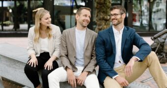 best real estate agents in seattle; get happy at home team; compass real estate washington; team sitting and looking at each other laughing