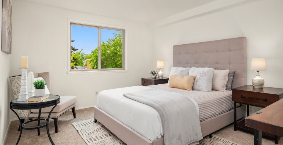 Cozy master bedroom with scenic views and ample natural light in North Seattle condo