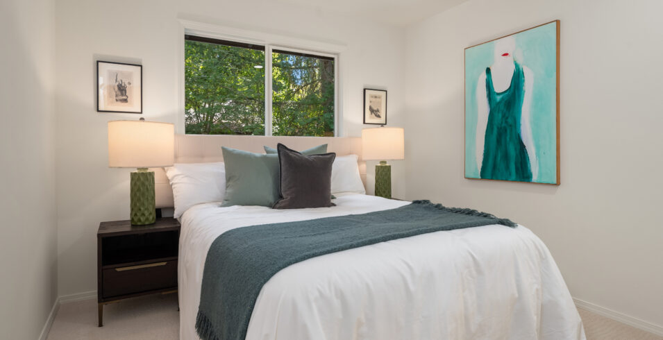 Bedroom with queen bed and garden window view in Kirkland Highlands home