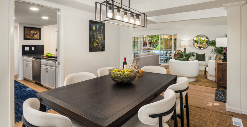 Dining room with vaulted ceiling and skylight opening to kitchen in Kirkland Highlands home