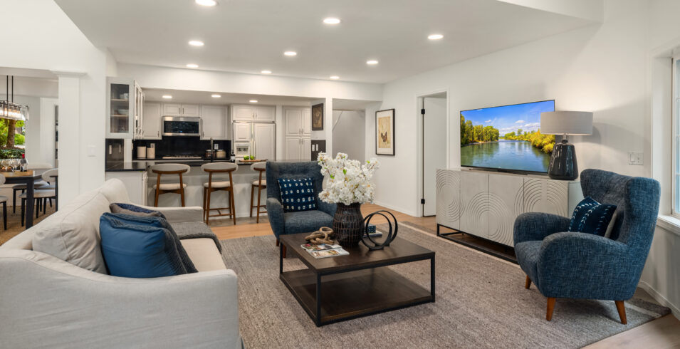 Family room with television wall and kitchen breakfast bar seating in Kirkland Highlands home