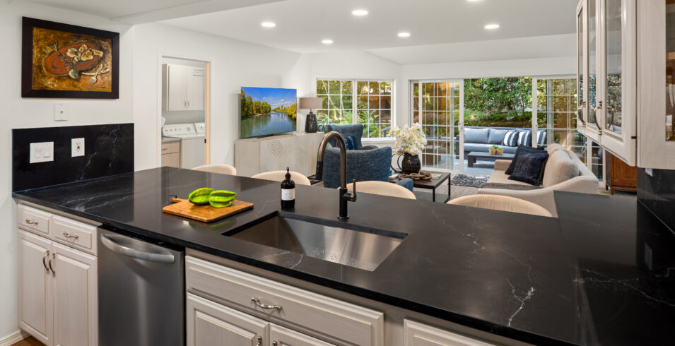 Kitchen sink with new black faucet and black quartz counters in Kirkland Highlands home for sale