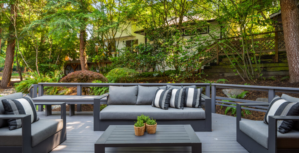 Freshly restored deck with outdoor lounge seating facing greenbelt in Kirkland Highlands home