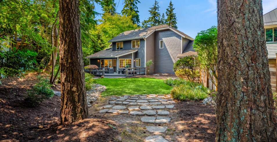 Stone path through fir trees looking back at Kirkland Highlands home