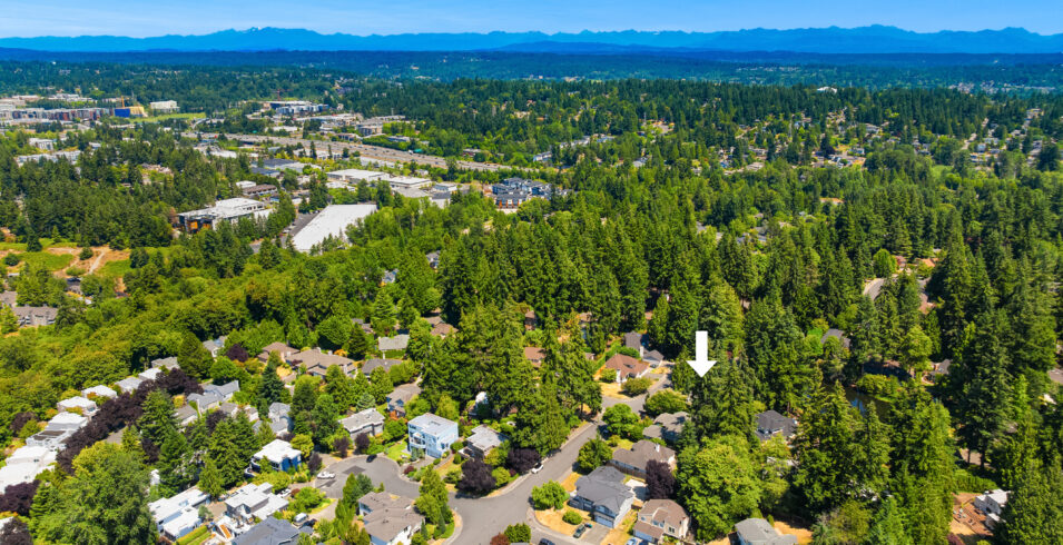 Aerial view with arrow marking home near community pond in Kirkland WA