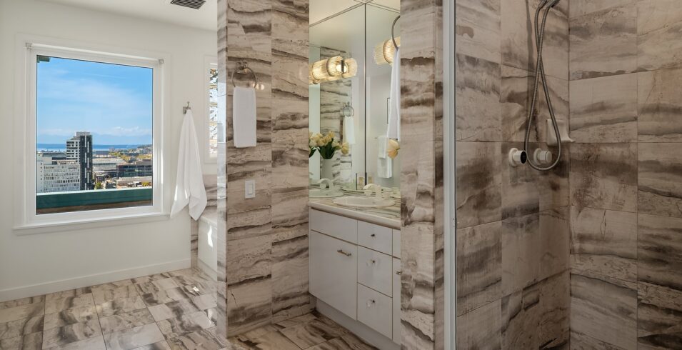 Upper bath with glass shower and stone-look tile